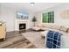 Comfortable living room with a fireplace, large window, and neutral décor, creating a welcoming atmosphere at 2833 Open Sky Way, Castle Rock, CO 80109