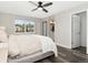 Comfortable main bedroom features a neutral color palette, bright window, and attached bathroom at 2833 Open Sky Way, Castle Rock, CO 80109