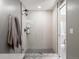 Contemporary shower with vertical white tiling, glass door, and black hardware at 2833 Open Sky Way, Castle Rock, CO 80109