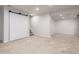 Large, finished basement area with carpet and lighting, perfect for recreation or additional living space at 606 Beth Ave, Fort Lupton, CO 80621