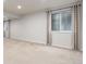 Finished basement area with carpet, offering versatile space for living or entertainment at 606 Beth Ave, Fort Lupton, CO 80621