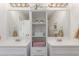 Stylish bathroom featuring dual vanity sinks, ample storage, and elegant decor accents at 606 Beth Ave, Fort Lupton, CO 80621