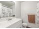 Bright bathroom features a white vanity, large mirror, and a shower with stylish curtain at 606 Beth Ave, Fort Lupton, CO 80621