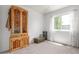 Guest bedroom with a cedar wardrobe trunk, natural light from the window, and neutral carpet at 606 Beth Ave, Fort Lupton, CO 80621
