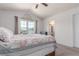 Light-filled bedroom featuring a quaint patchwork quilt, and an ensuite bathroom at 606 Beth Ave, Fort Lupton, CO 80621