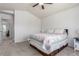 Bedroom featuring a neutral color palette, with a queen bed and access to ensuite bath at 606 Beth Ave, Fort Lupton, CO 80621