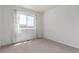 Clean, bright bedroom with large window providing ample natural light and a neutral carpet at 606 Beth Ave, Fort Lupton, CO 80621