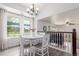 A bright and airy dining room features laminate floors and modern chandelier at 606 Beth Ave, Fort Lupton, CO 80621