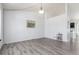 Bright and open dining room featuring gray wood flooring and vaulted ceiling at 606 Beth Ave, Fort Lupton, CO 80621