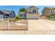 Beautiful two-story home boasts a manicured lawn, white picket fence, and spacious driveway at 606 Beth Ave, Fort Lupton, CO 80621