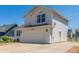 Two-story home with a spacious driveway and a side door entrance at 606 Beth Ave, Fort Lupton, CO 80621