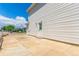 Side view of home features large stone paver patio and side entrance at 606 Beth Ave, Fort Lupton, CO 80621