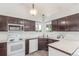 Kitchen features stainless steel sink, bright countertops, and wooden cabinetry at 606 Beth Ave, Fort Lupton, CO 80621