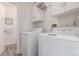 Functional laundry room featuring modern washer and dryer units at 606 Beth Ave, Fort Lupton, CO 80621