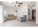 The living room features neutral walls, carpet, ceiling fan, and an adjacent laundry room at 606 Beth Ave, Fort Lupton, CO 80621
