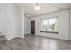 Bright, spacious living room with wood-look flooring and large windows at 606 Beth Ave, Fort Lupton, CO 80621