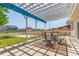 Relaxing patio area with a pergola, dining set, and views of the surrounding neighborhood at 606 Beth Ave, Fort Lupton, CO 80621