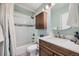 Cozy bathroom features a tub with tiled walls and a wood vanity cabinet at 19624 E Girard Dr, Aurora, CO 80013