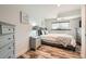 Comfortable bedroom features hardwood floors, a full sized bed, and matching nightstand and dresser at 19624 E Girard Dr, Aurora, CO 80013