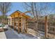 A beautiful backyard wooden chicken coop situated on a white rock bed and grass at 19624 E Girard Dr, Aurora, CO 80013