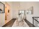 Modern dining room boasts hardwood floors, a contemporary chandelier, and neutral decor at 19624 E Girard Dr, Aurora, CO 80013