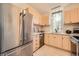 Updated kitchen featuring stainless steel appliances, neutral cabinets, and plenty of natural light at 19624 E Girard Dr, Aurora, CO 80013