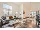 Open concept living area with dark hardwood floors flowing into the dining area at 19624 E Girard Dr, Aurora, CO 80013