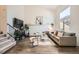 Bright living room featuring hardwood floors, a vaulted ceiling, and a large window at 19624 E Girard Dr, Aurora, CO 80013