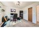 Comfortable home office space featuring a modern light fixture, practical shelving and neutral carpeting at 19624 E Girard Dr, Aurora, CO 80013