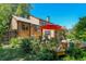 Inviting back deck with outdoor seating, a vibrant red umbrella, and lush landscaping, perfect for entertaining at 260 E Cornwall Ct, Lafayette, CO 80026