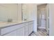 Bathroom featuring dual sinks and marble-look tile flooring at 14587 W 90Th Ln # B, Arvada, CO 80005