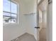 Walk-in closet featuring neutral carpet, a window, and rod for hanging clothes at 14587 W 90Th Ln # B, Arvada, CO 80005