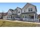 Charming townhomes featuring modern architecture and a well-manicured lawn at 14587 W 90Th Ln # B, Arvada, CO 80005