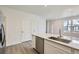 Modern kitchen featuring an island with a sink and stainless steel appliances at 14587 W 90Th Ln # B, Arvada, CO 80005