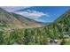 A charming mountain valley view shows homes nestled among the trees, with mountains and skies surrounding the neighborhood at 1890 Argentine St # C301, Georgetown, CO 80444