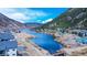 Beautiful aerial view of a neighborhood nestled in the mountains with a blue river running through it on a sunny day at 1890 Argentine St # C301, Georgetown, CO 80444