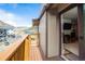 Balcony with beautiful lake views looking into a living room with a TV and an entertainment center at 1890 Argentine St # C301, Georgetown, CO 80444