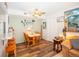 Dining room with a wood table set for four, a view into the living room, and a ceiling fan above at 1890 Argentine St # C301, Georgetown, CO 80444