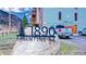 Charming condo building at 1890 Argentine St, with mountain views and a rustic stone sign at 1890 Argentine St # C301, Georgetown, CO 80444