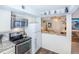 Well-equipped kitchen with stainless steel appliances, granite countertops, and a breakfast bar leading to the dining area at 1890 Argentine St # C301, Georgetown, CO 80444