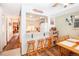 View of the kitchen and dining area showing barstool seating and bright, natural light from a window at 1890 Argentine St # C301, Georgetown, CO 80444