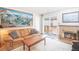 Cozy living room featuring a fireplace, a map of Breckenridge, and a sliding glass door to a deck at 1890 Argentine St # C301, Georgetown, CO 80444