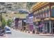 Charming street view with colorful buildings, American flag, and sidewalk seating at 1890 Argentine St # C301, Georgetown, CO 80444