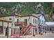 Charming street view featuring unique building designs, American flags, and street flowers, creating a picturesque scene at 1890 Argentine St # C301, Georgetown, CO 80444
