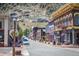 A lively street scene features colorful buildings and parked cars against a backdrop of rocky mountain terrain at 1890 Argentine St # C301, Georgetown, CO 80444