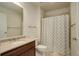 Bathroom features a single sink with cabinet, a large mirror, and a shower at 2200 S University Blvd # 313, Denver, CO 80210