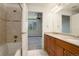 A bathroom features double sinks with cabinets, shower and view to the bedroom at 2200 S University Blvd # 313, Denver, CO 80210