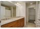 Bathroom features double sinks with cabinets, large mirror, shower and walk-in closet at 2200 S University Blvd # 313, Denver, CO 80210