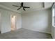 Empty bedroom with a ceiling fan, carpeted floor, and access to a nearby bathroom at 2200 S University Blvd # 313, Denver, CO 80210
