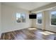 Bright bedroom with large windows, wood flooring, and modern lighting at 2200 S University Blvd # 313, Denver, CO 80210